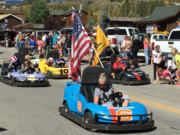 A thumb nail view of Grand Lake, Colorado during Constitution Week in September looking at the Scorpion King Go Carts as they go down Grand Avenue in the Parade; click here to open a window with a larger picture.